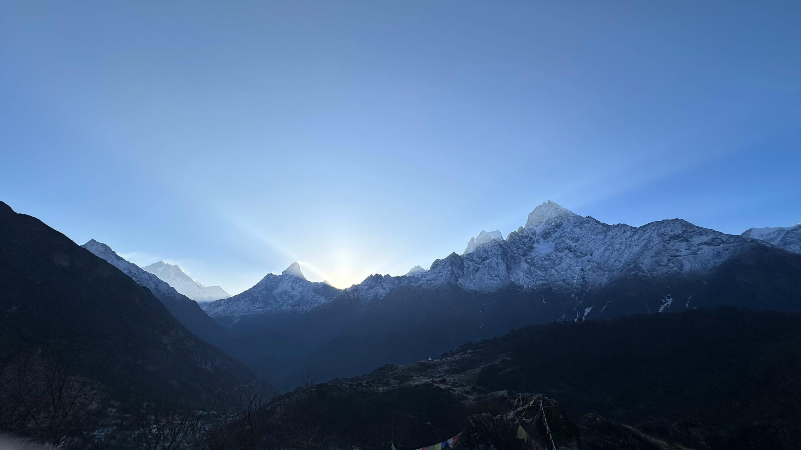 Breathtaking sunrise over snow-capped Himalayas with clear skies.