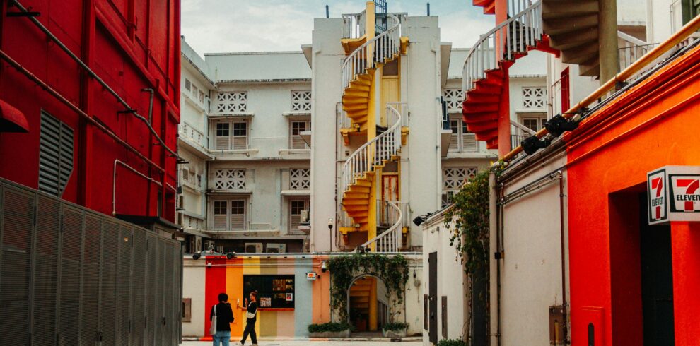 Vibrant spiraled staircases in a Singaporean laneway capture urban charm.