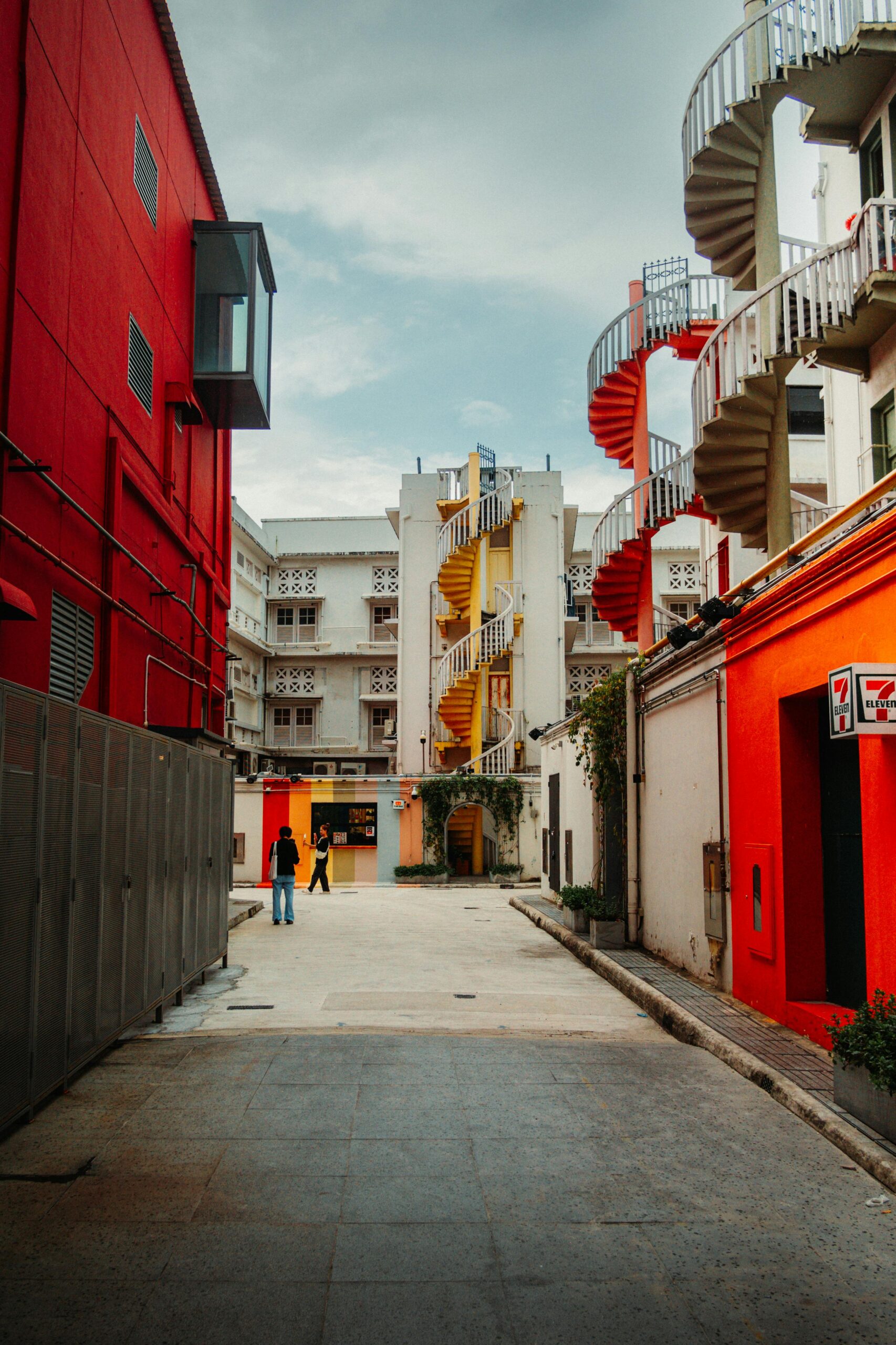 Vibrant spiraled staircases in a Singaporean laneway capture urban charm.