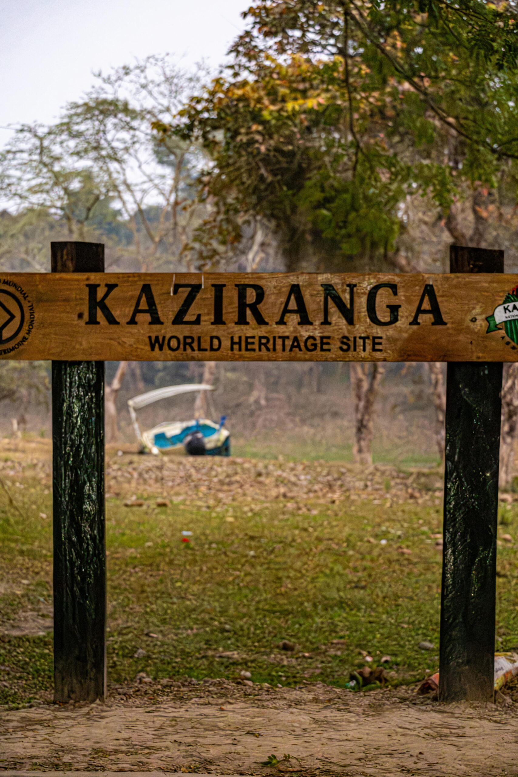 Sign at Kaziranga World Heritage Site entrance, India, amidst lush greenery.