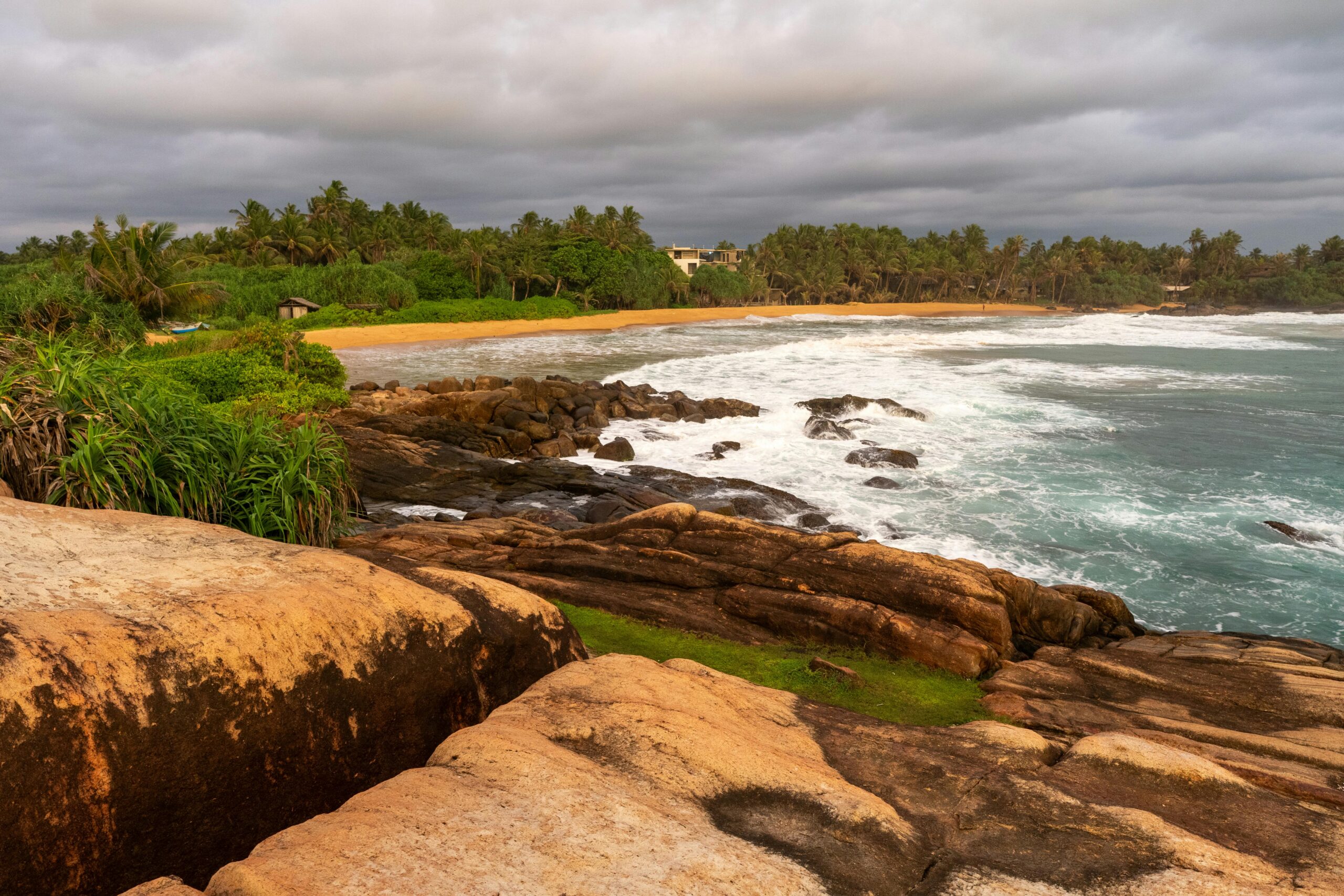 Beautiful beach and rocky shoreline view captured at sunset in Sri Lanka