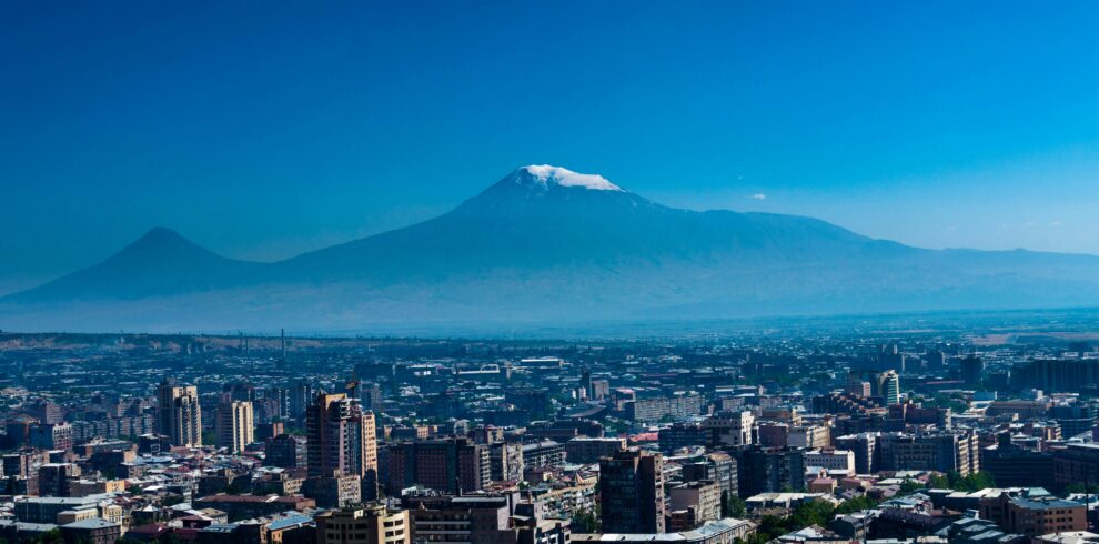 Stunning aerial panorama of Yerevan cityscape with the majestic Mount Ararat in the background, offering a scenic view.