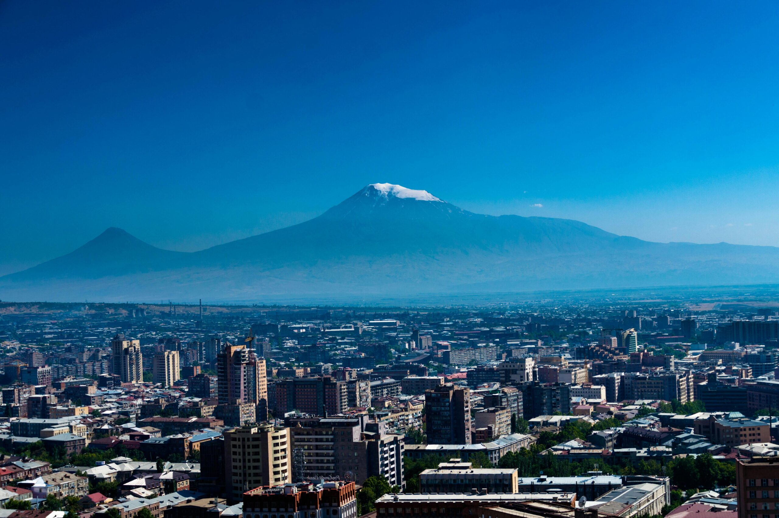 Stunning aerial panorama of Yerevan cityscape with the majestic Mount Ararat in the background, offering a scenic view.