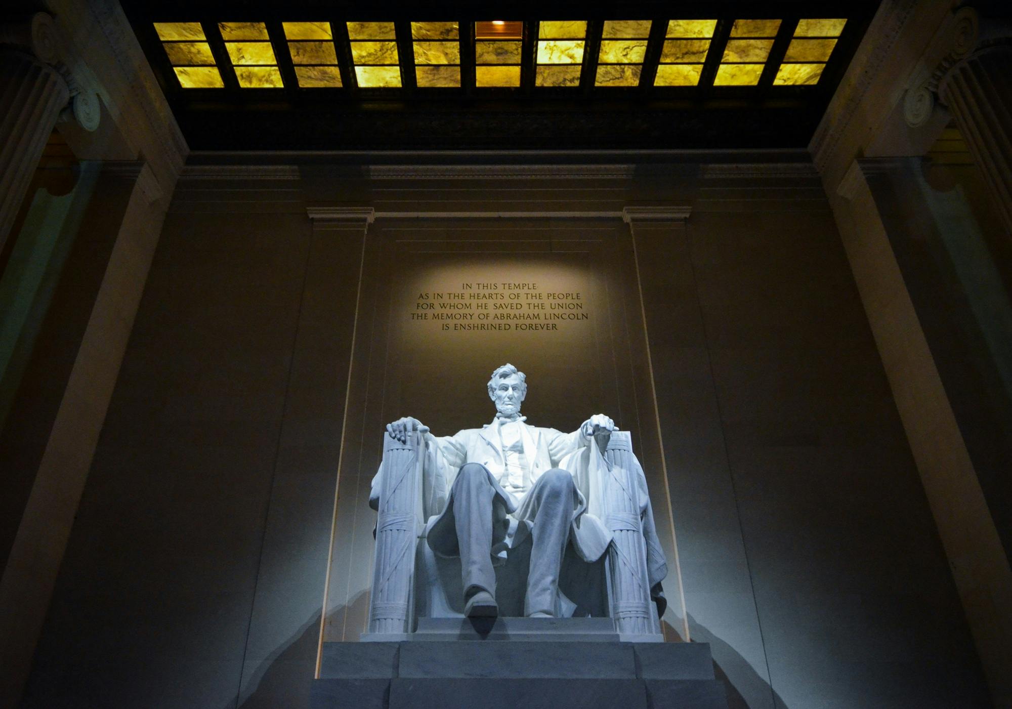 Dramatic low angle view of Abraham Lincoln sculpture inside Lincoln Memorial, Washington DC.