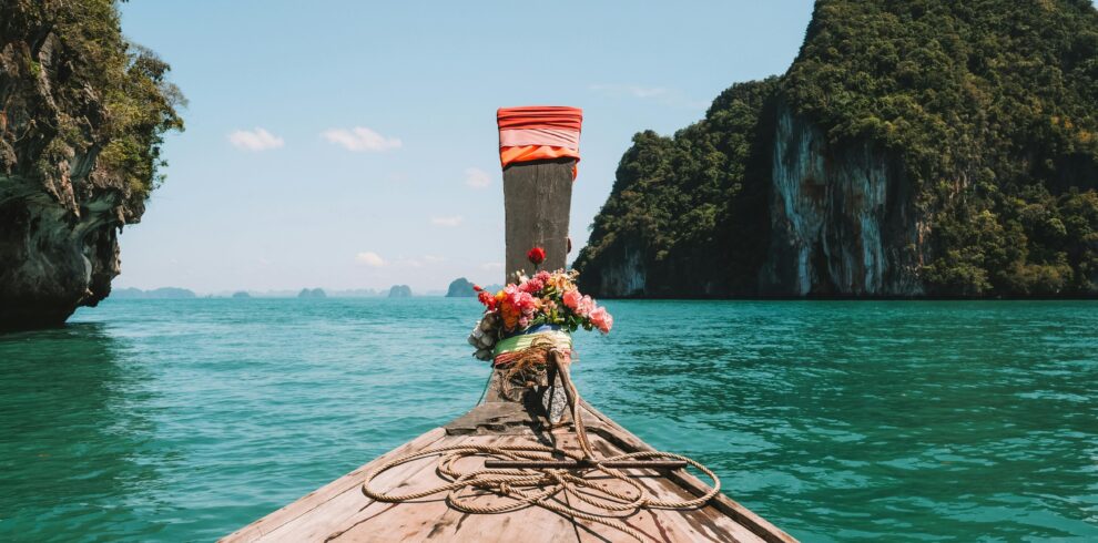 Explore stunning turquoise waters in Krabi, Thailand aboard a traditional longtail boat.