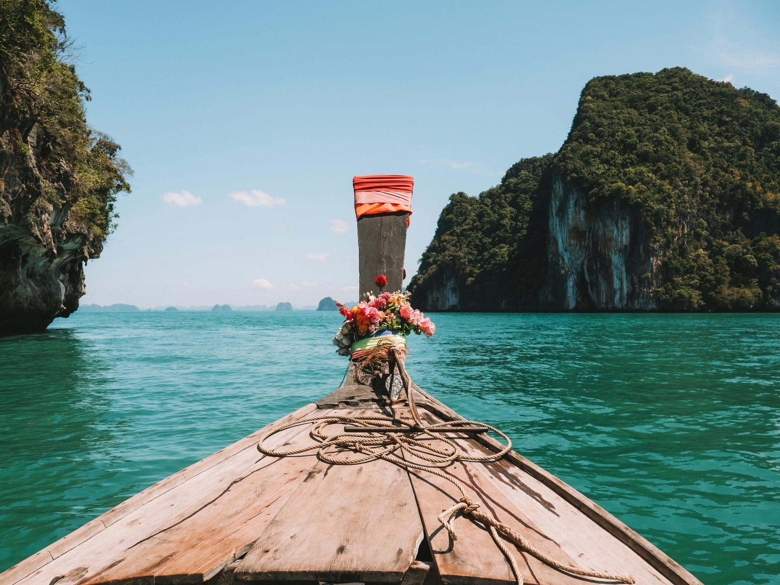 Explore stunning turquoise waters in Krabi, Thailand aboard a traditional longtail boat.