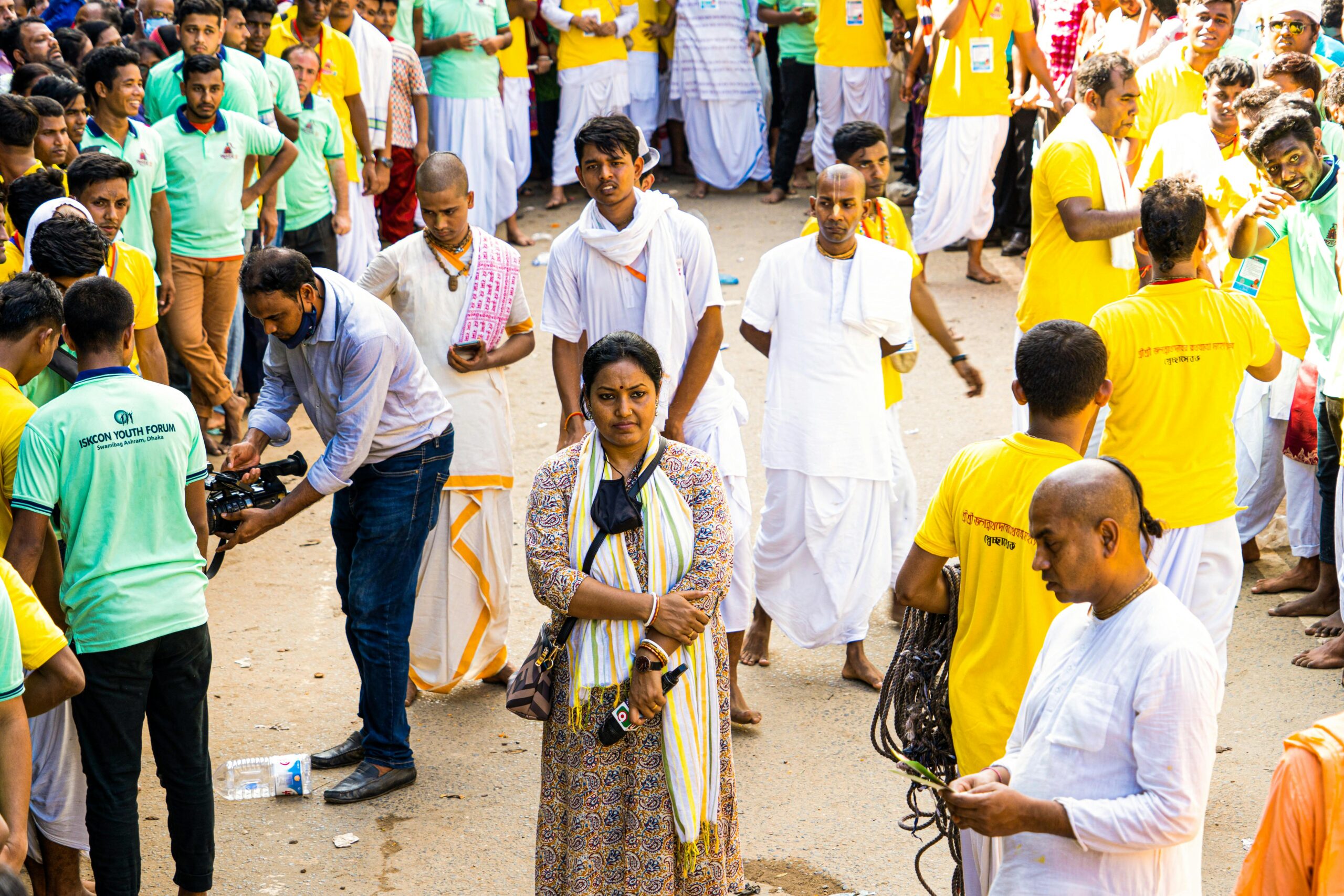 Colorful festival scene with crowds celebrating on the streets of Dhaka, Bangladesh.