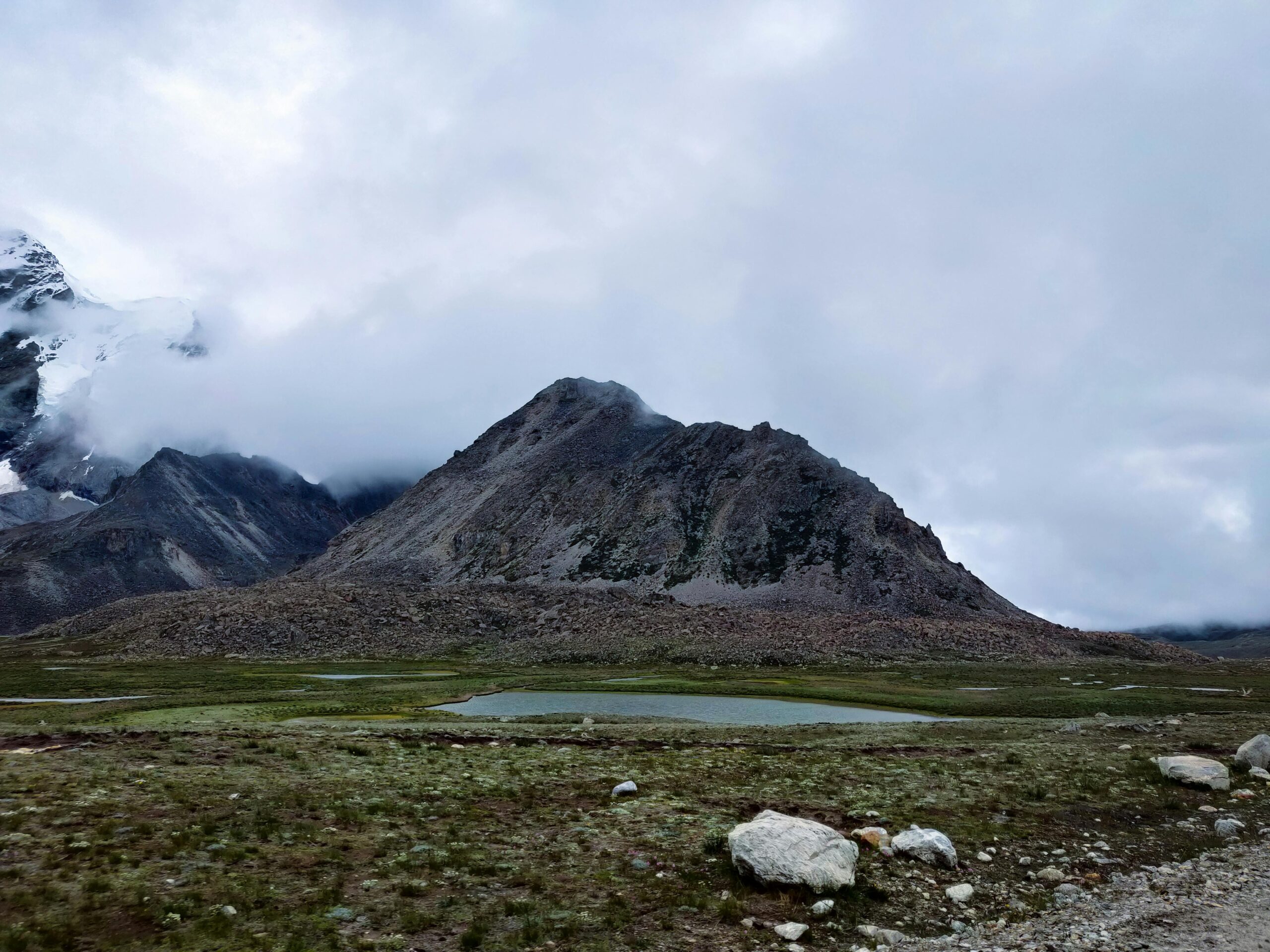 Scenic view of a majestic mountain with a cloudy sky in North Sikkim, India.