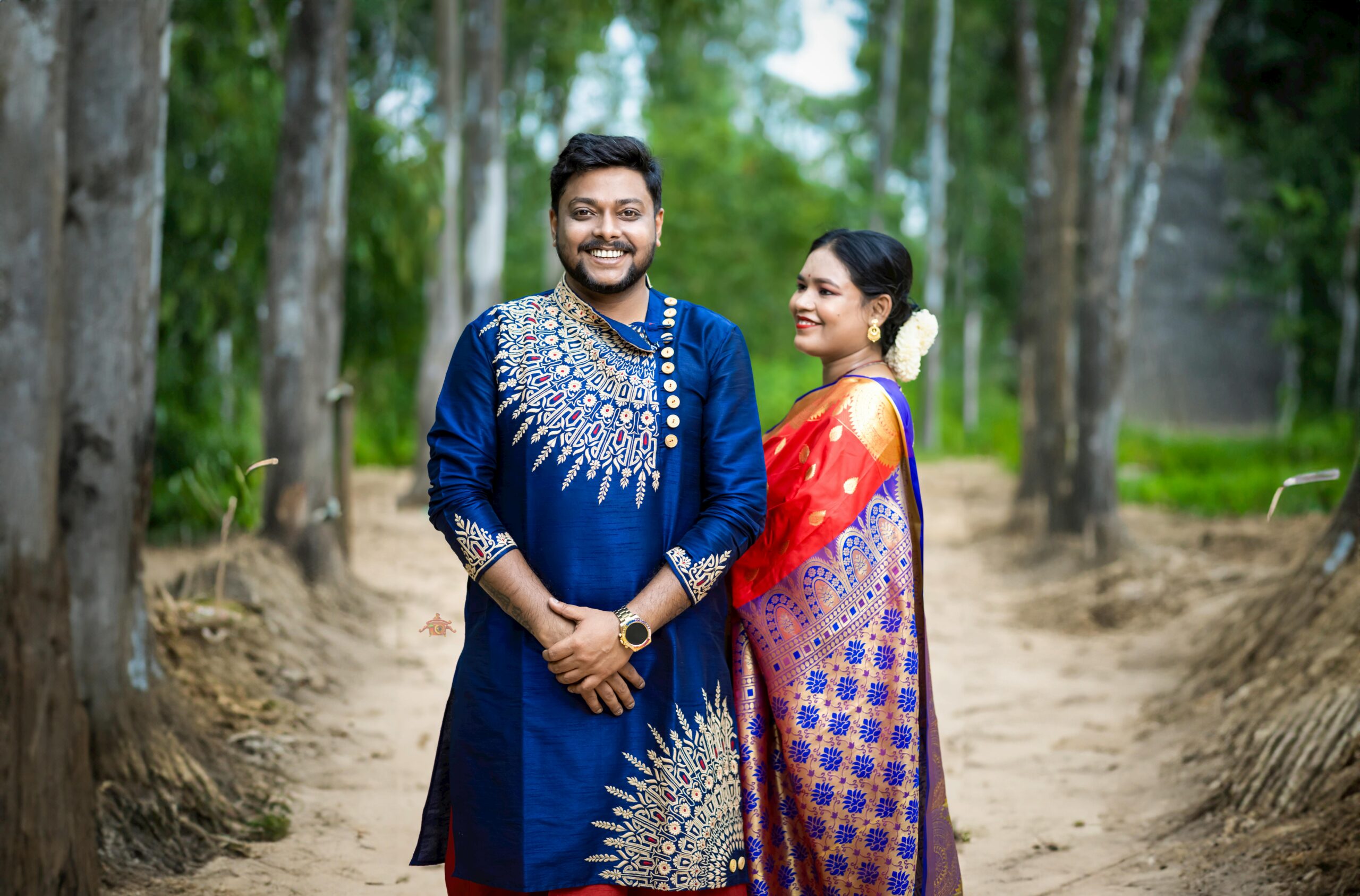 A joyful Bengali couple posing in traditional attire during a pre-wedding shoot in Santiniketan.