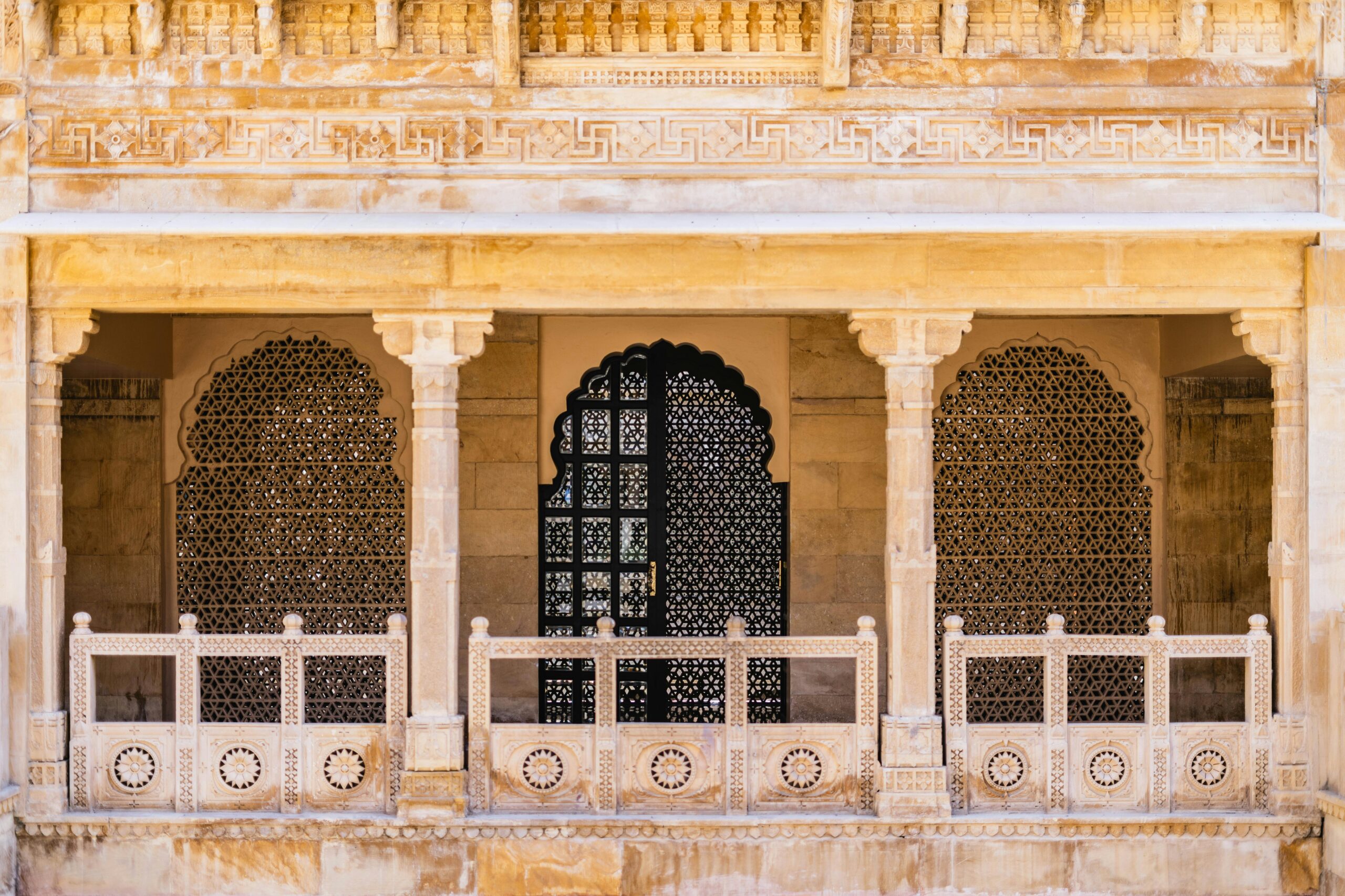 Beautifully carved stone arches and facades showcasing traditional Jaisalmer architecture.