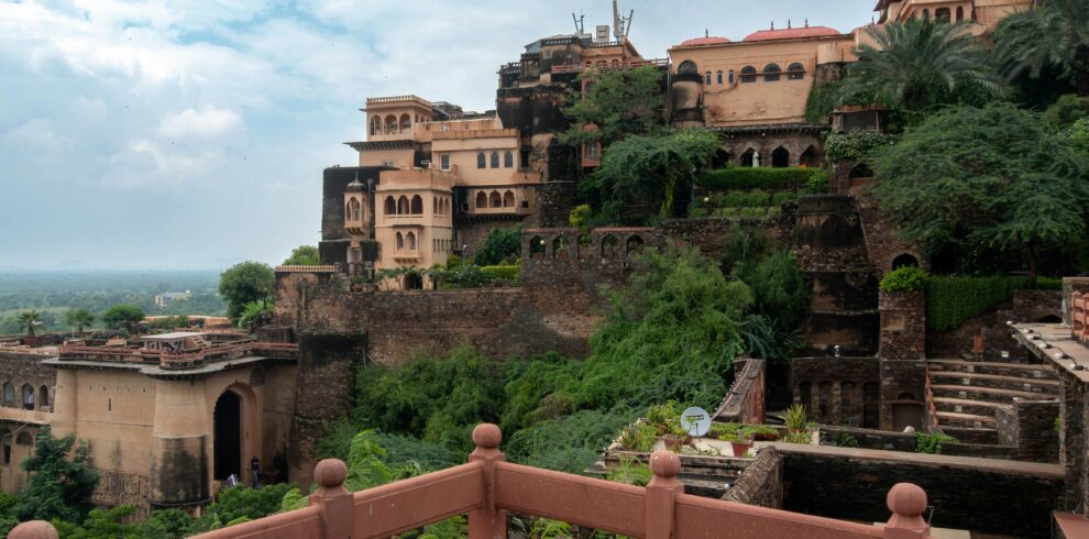 Explore the historic Neemrana Fort in Rajasthan, showcasing ancient architecture and lush greenery.