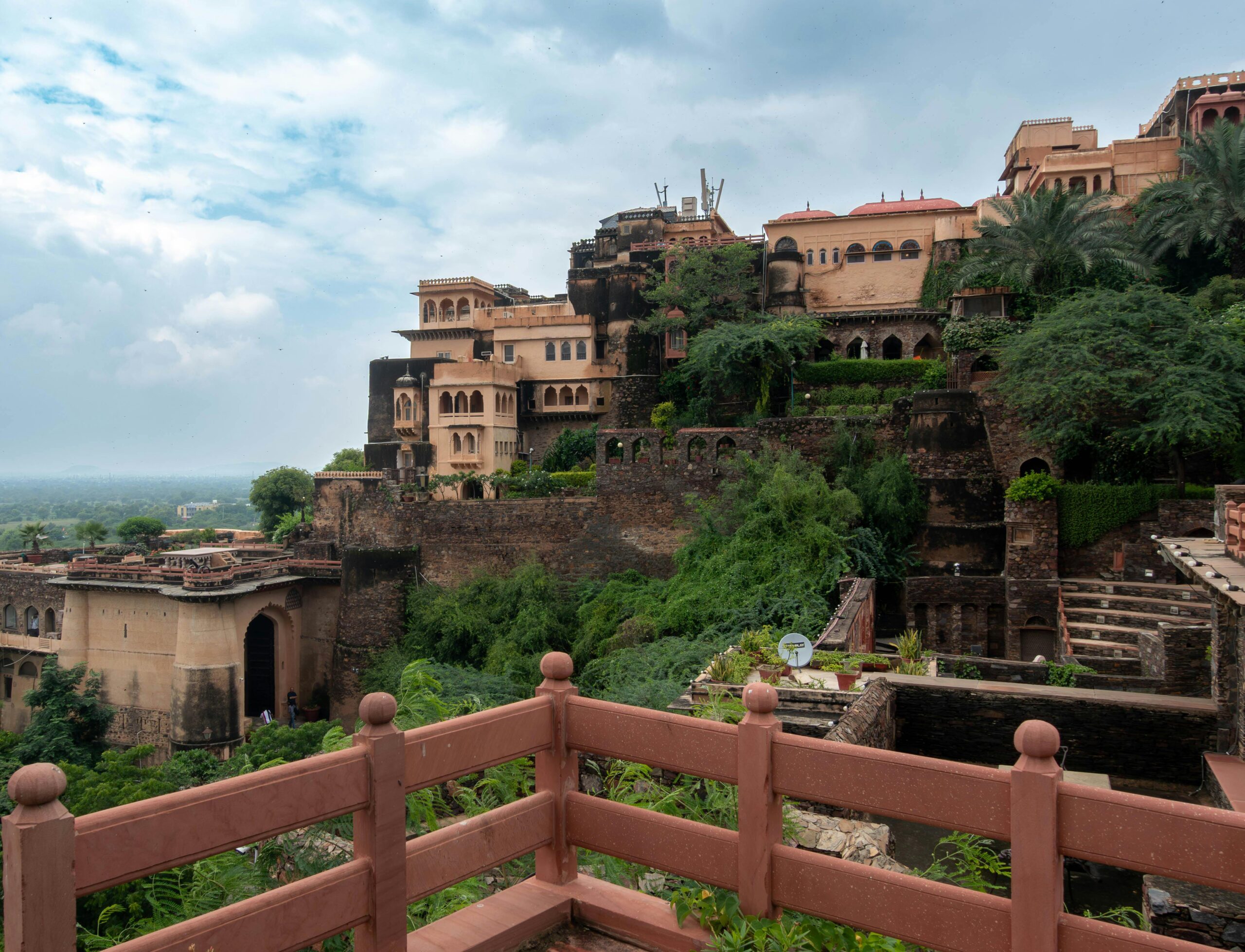 Explore the historic Neemrana Fort in Rajasthan, showcasing ancient architecture and lush greenery.