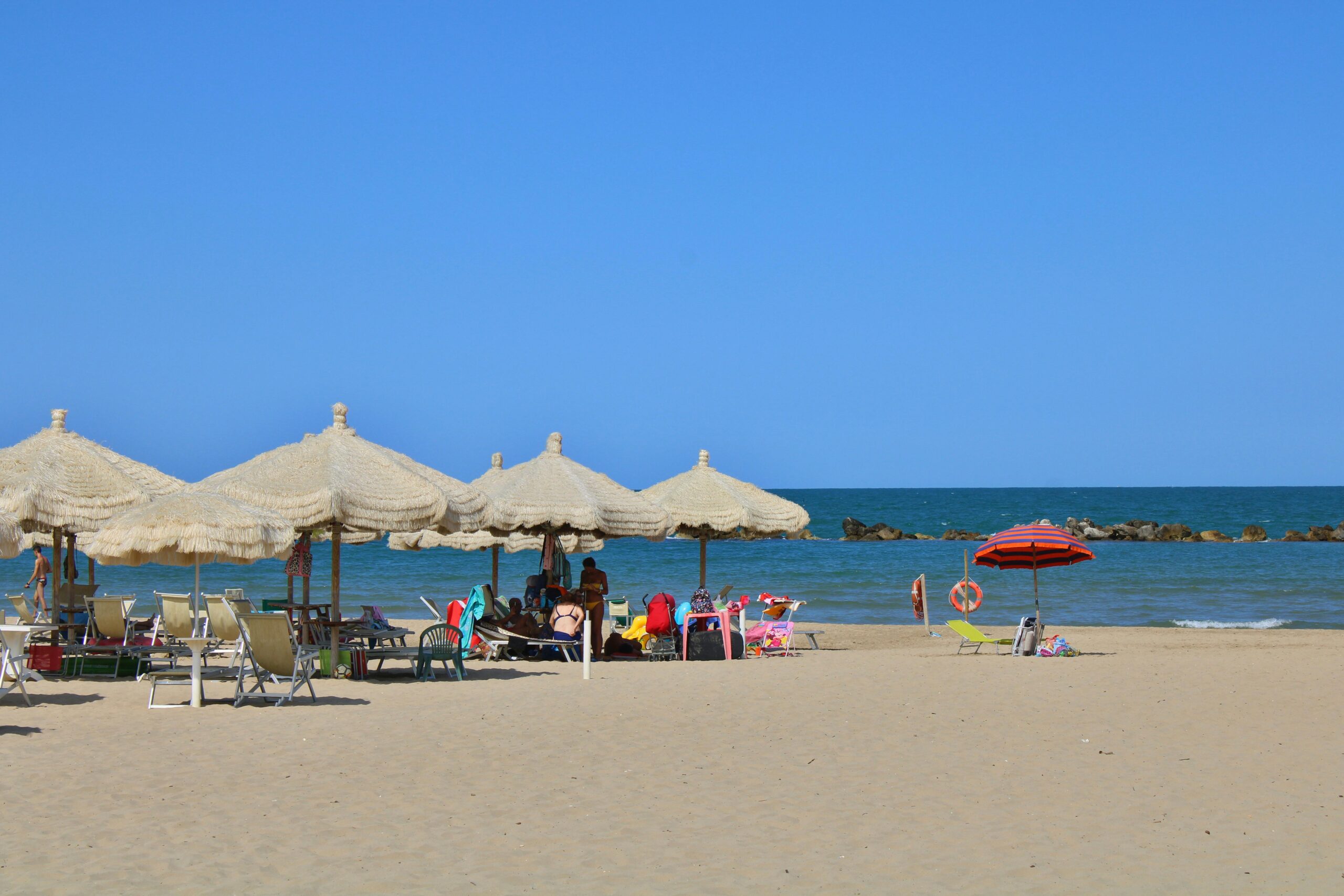 Relax by the sea under umbrellas on Fossacesia beach, Abruzzo, Italy.